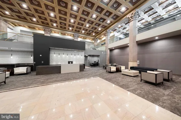 a kitchen with stainless steel appliances granite countertop a refrigerator a stove a sink and a microwave with wooden floor