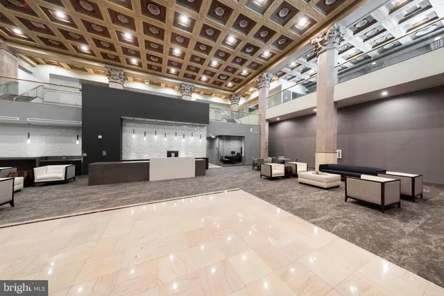 a kitchen with stainless steel appliances granite countertop a refrigerator a stove a sink and a microwave with wooden floor