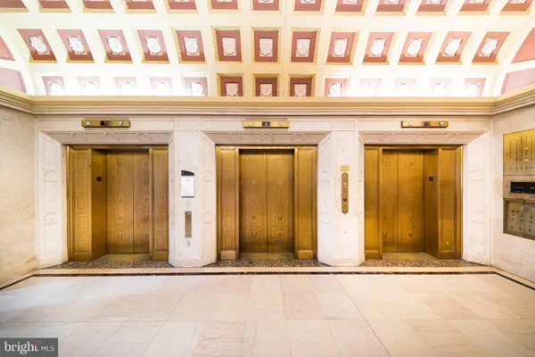 a living room with furniture and a lamp