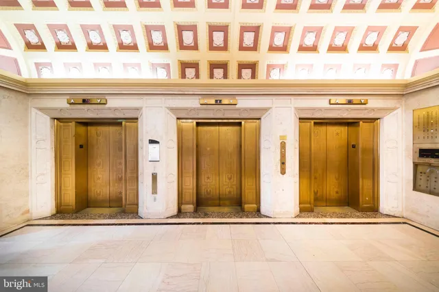 a living room with furniture and a lamp