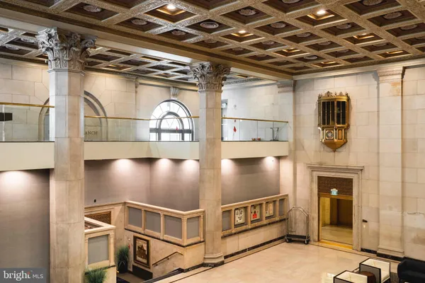 a living room with furniture a chandelier and a dining table