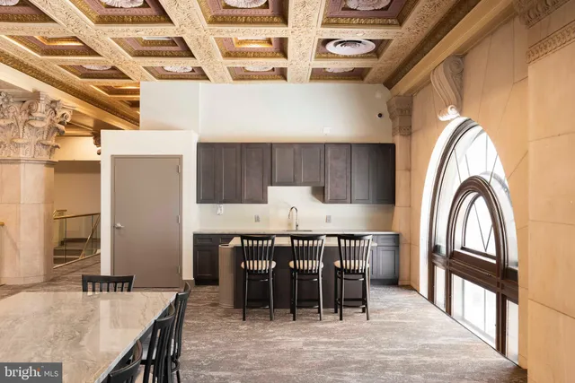 a kitchen with stainless steel appliances granite countertop a sink a stove and a wooden floors