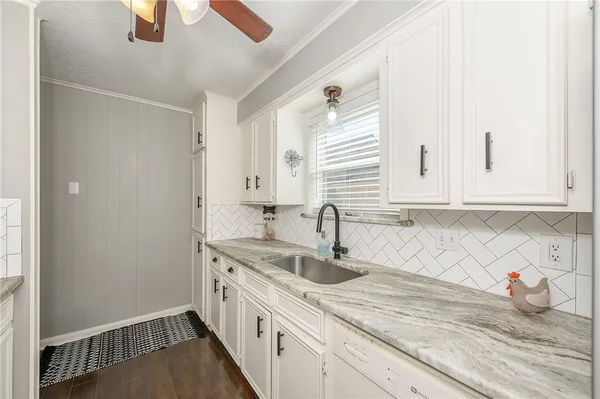 a kitchen with a sink and cabinets