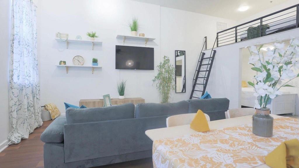 2004 North Howard Avenue, Unit 203 Tampa, FL 33607 - Photo 12 of 16 a living room with furniture and a flat screen tv