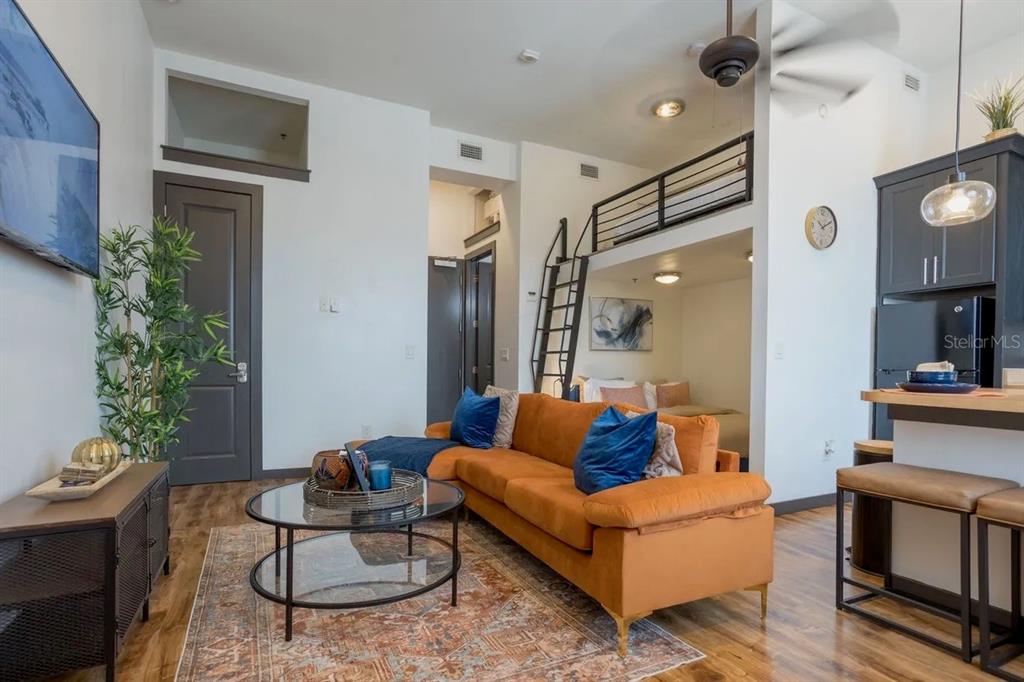 2004 North Howard Avenue, Unit 203 Tampa, FL 33607 - Photo 2 of 16 a living room with furniture and a fireplace