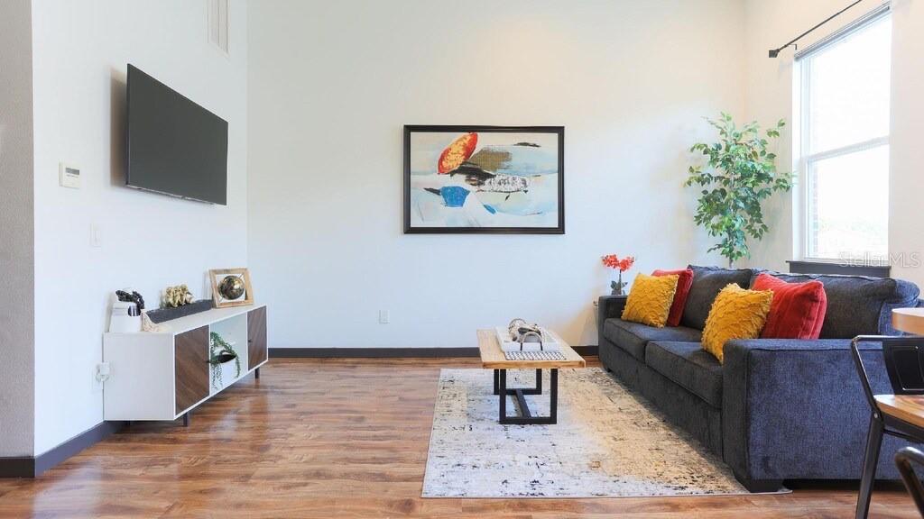 2004 North Howard Avenue, Unit 203 Tampa, FL 33607 - Photo 3 of 16 a living room with furniture and a flat screen tv