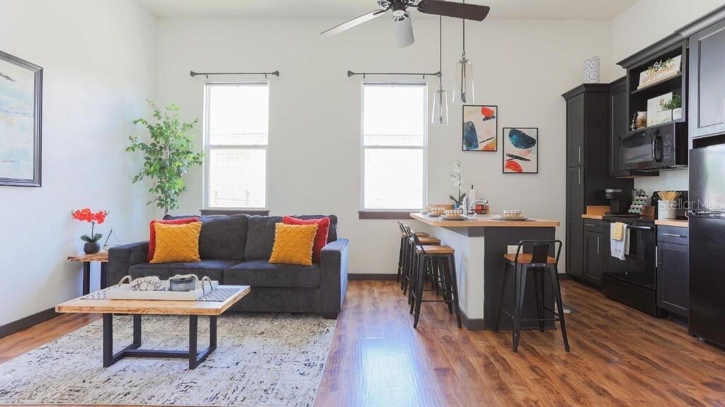2004 North Howard Avenue, Unit 203 Tampa, FL 33607 - Photo 4 of 16 a living room with furniture and a table