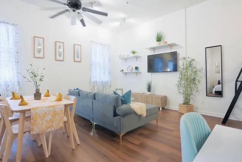 2004 North Howard Avenue, Unit 203 Tampa, FL 33607 - Photo 6 of 16 a living room with furniture a flat screen tv and a fireplace