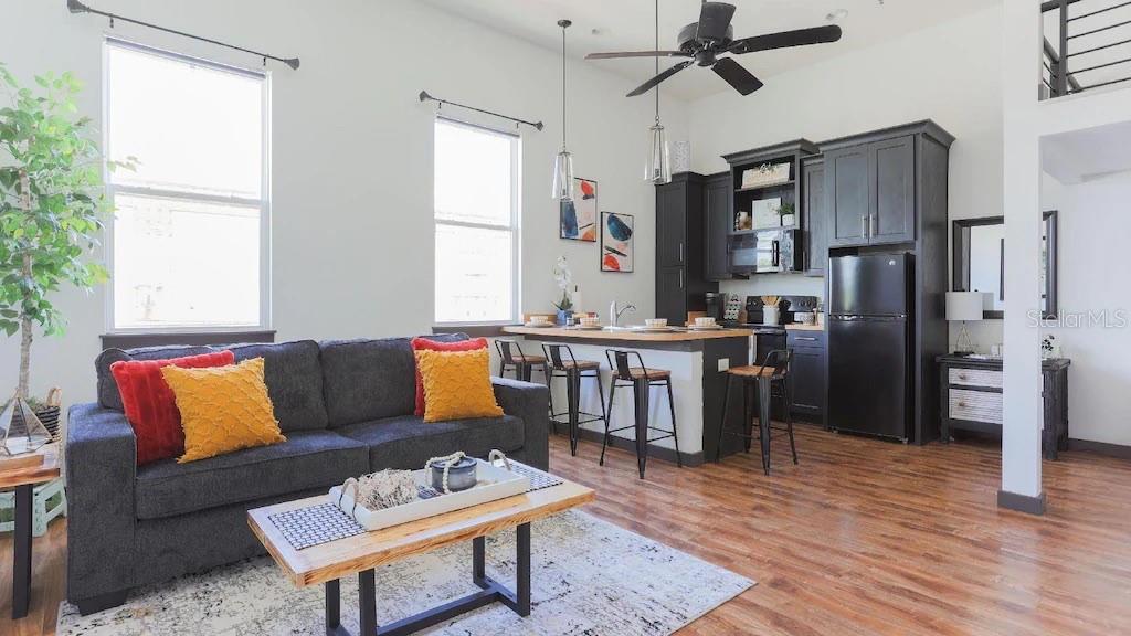 2004 North Howard Avenue, Unit 203 Tampa, FL 33607 - Photo 7 of 16 a living room with stainless steel appliances furniture a rug and a window
