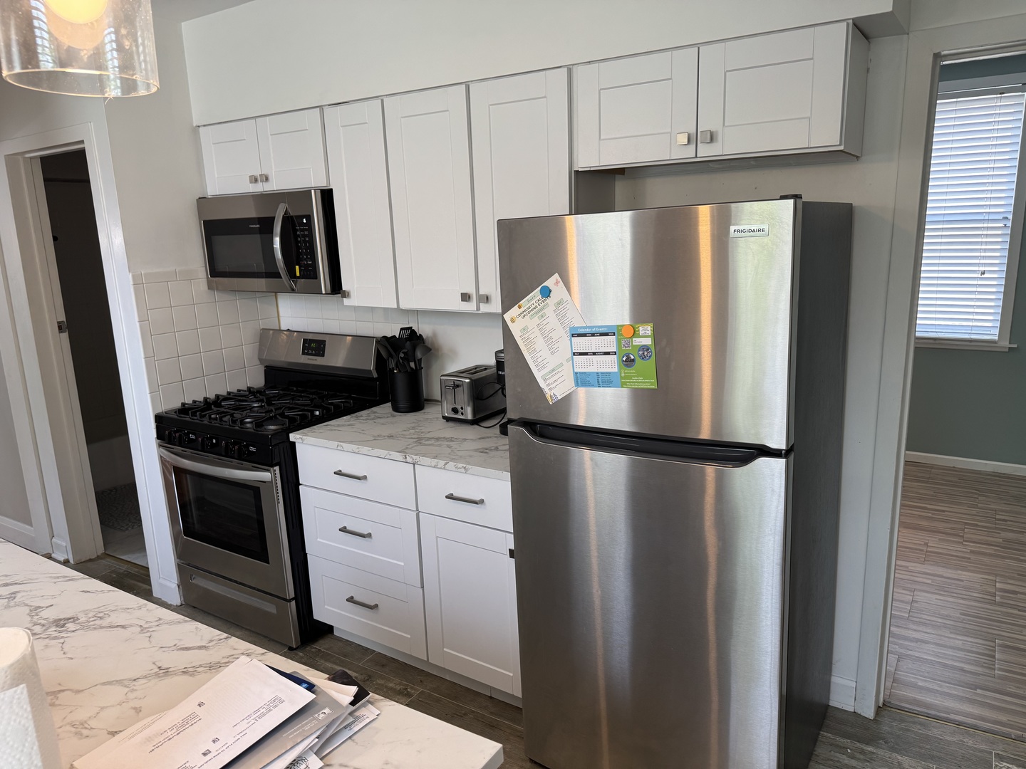 116 East Quincy Street, Unit 1 Riverside, IL 60546 - Photo 5 of 10 a kitchen with stainless steel appliances a refrigerator sink and microwave
