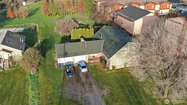 an aerial view of a house with a yard basket ball court and outdoor seating