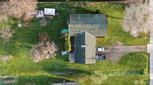 an aerial view of a house with a yard