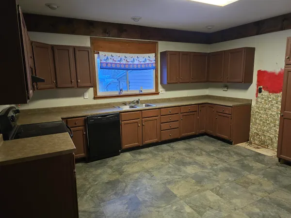a kitchen with sink and cabinets
