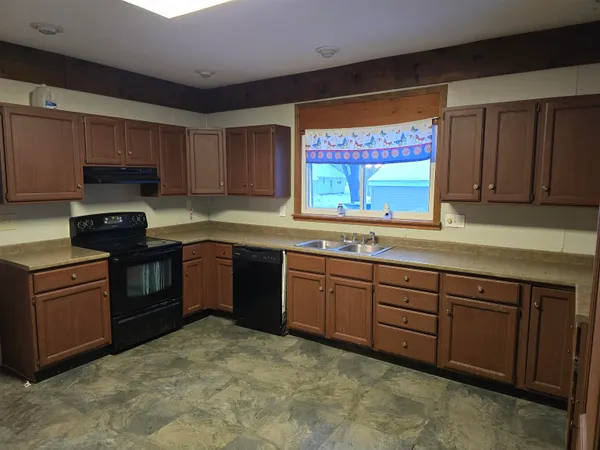 a kitchen with stainless steel appliances granite countertop a stove sink and cabinets
