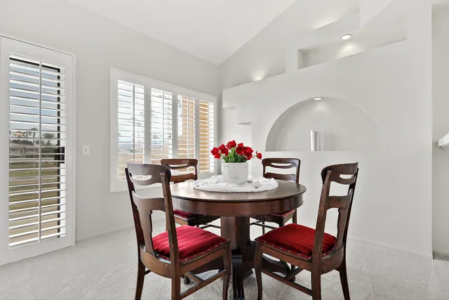 a dining room with furniture and window