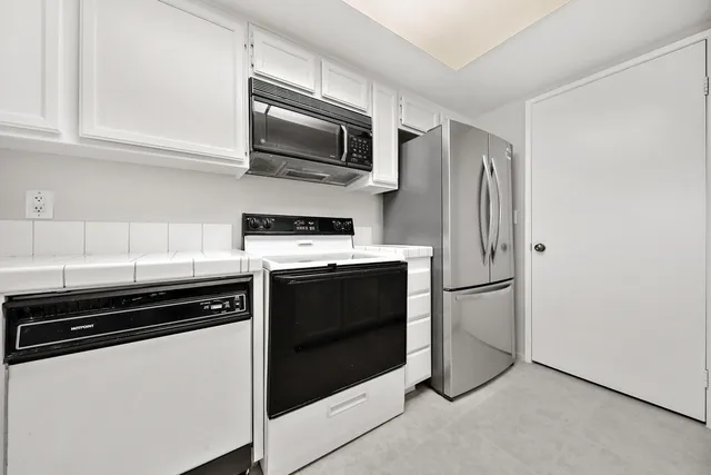 a kitchen with a refrigerator stove and microwave