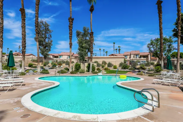a view of a swimming pool with outdoor seating
