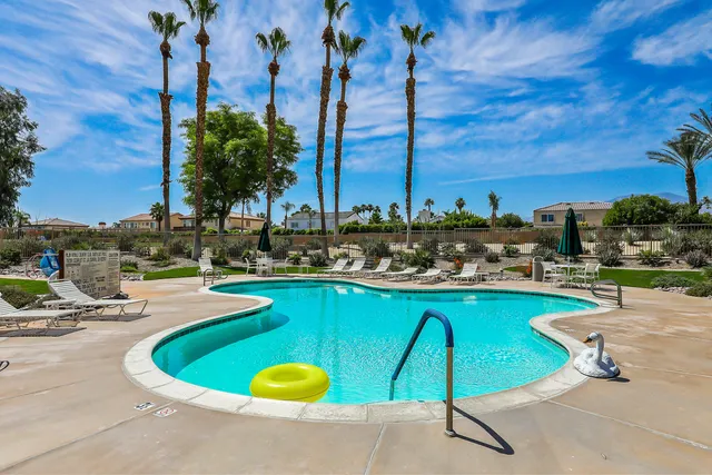 a view of a swimming pool with chairs