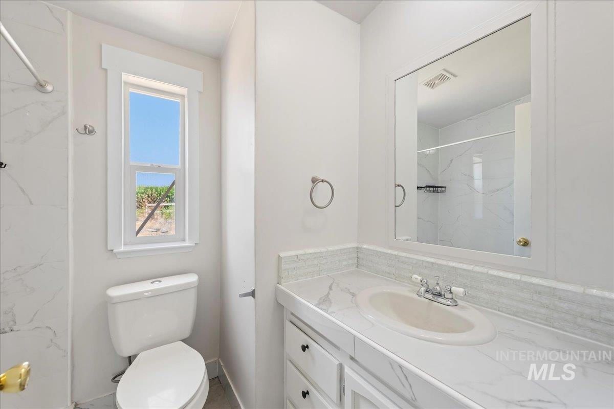 14490-14492 Sand Hollow Road Caldwell, ID 83607 - Photo 44 of 50 Full bathroom featuring vanity and a marble finish shower