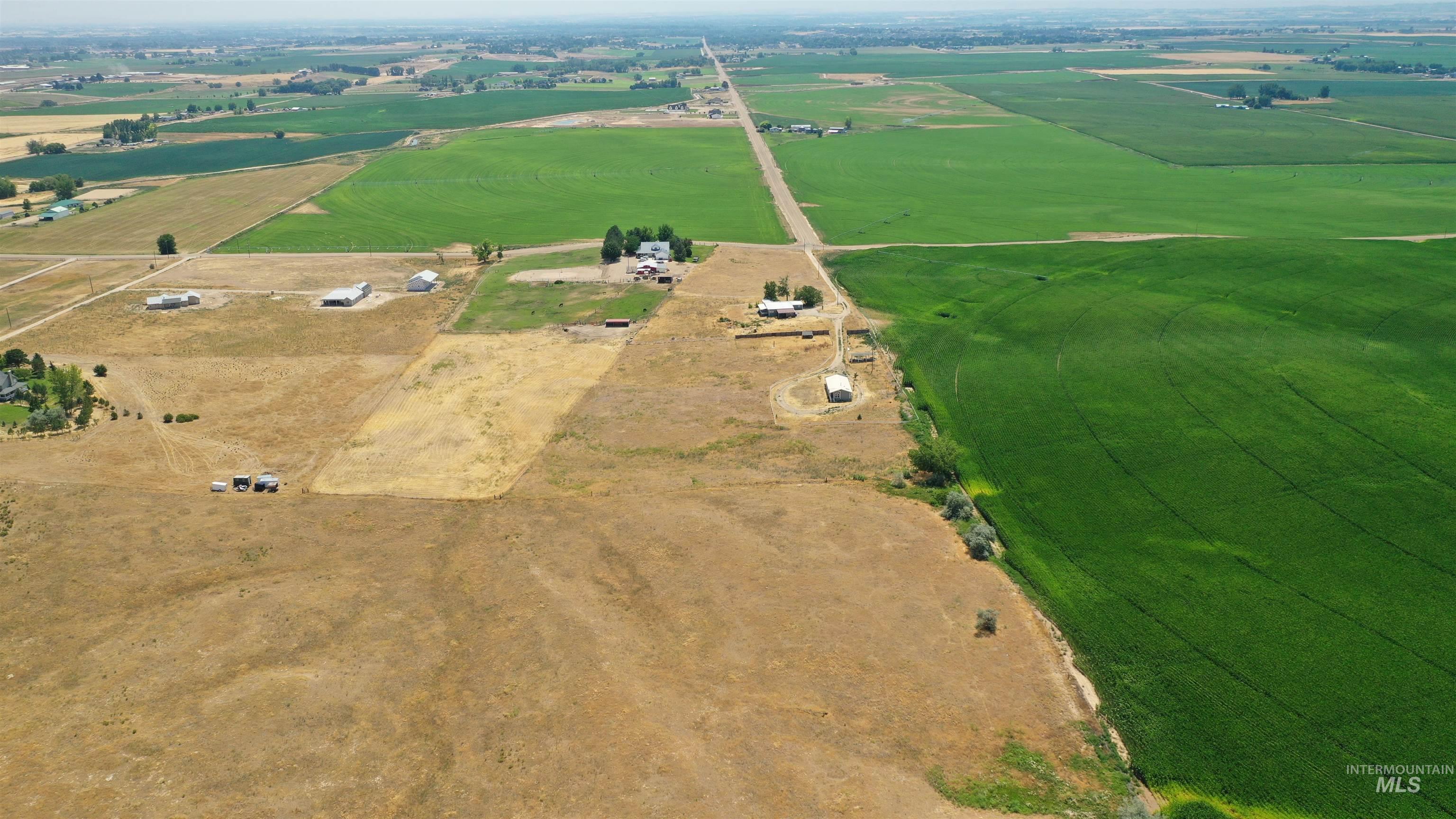 14490-14492 Sand Hollow Road Caldwell, ID 83607 - Photo 8 of 50 Aerial view of property and surrounding area with rural landscape and extensive farmland