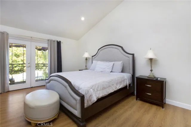 a bedroom with a bed and a large window