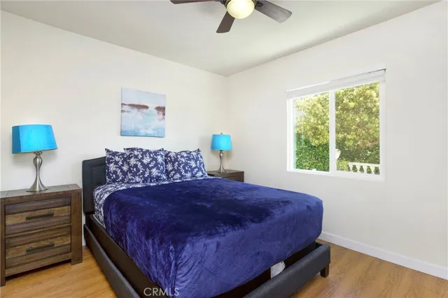 a large bed sitting in a bedroom next to a window