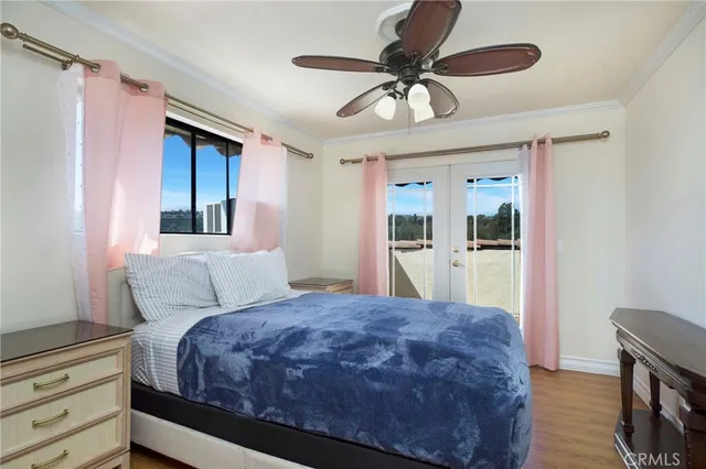 a bedroom with a large bed and a chandelier