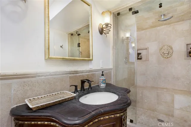 a bathroom with a granite countertop sink a toilet and mirror