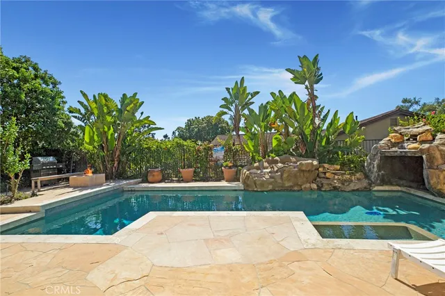 a view of a backyard with plants and outdoor seating