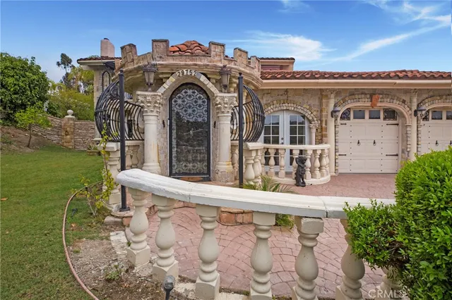 a front view of a house with a garden