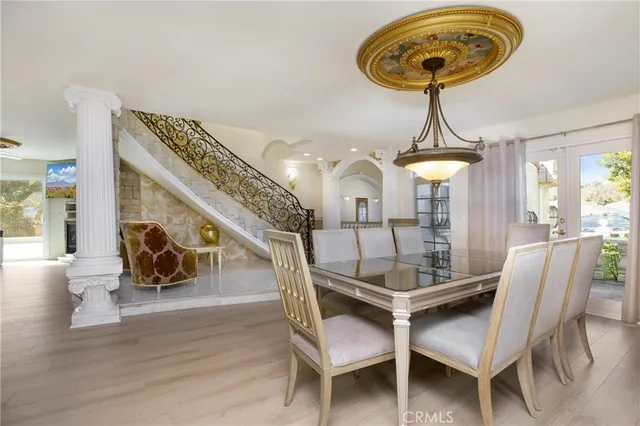 a view of a dining room with furniture wooden floor and chandelier