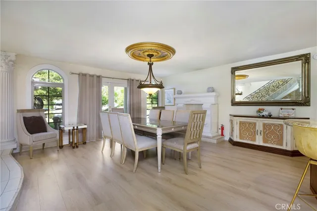 a dining room with furniture a chandelier and wooden floor