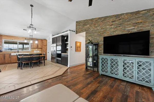 a kitchen with stainless steel appliances granite countertop a sink a stove a refrigerator and a refrigerator