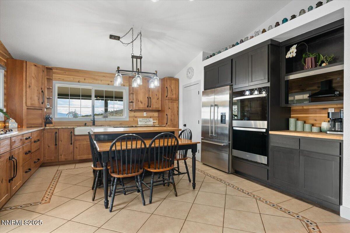 15030 North Red Rock Road Reno, NV 89508 - Photo 17 of 89 a kitchen with stainless steel appliances granite countertop a sink a stove a refrigerator and a refrigerator