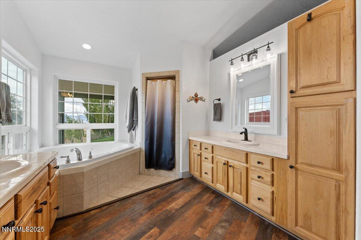 15030 North Red Rock Road Reno, NV 89508 - Photo 28 of 89 a large bathroom with a tub a double vanity sink a mirror and a window
