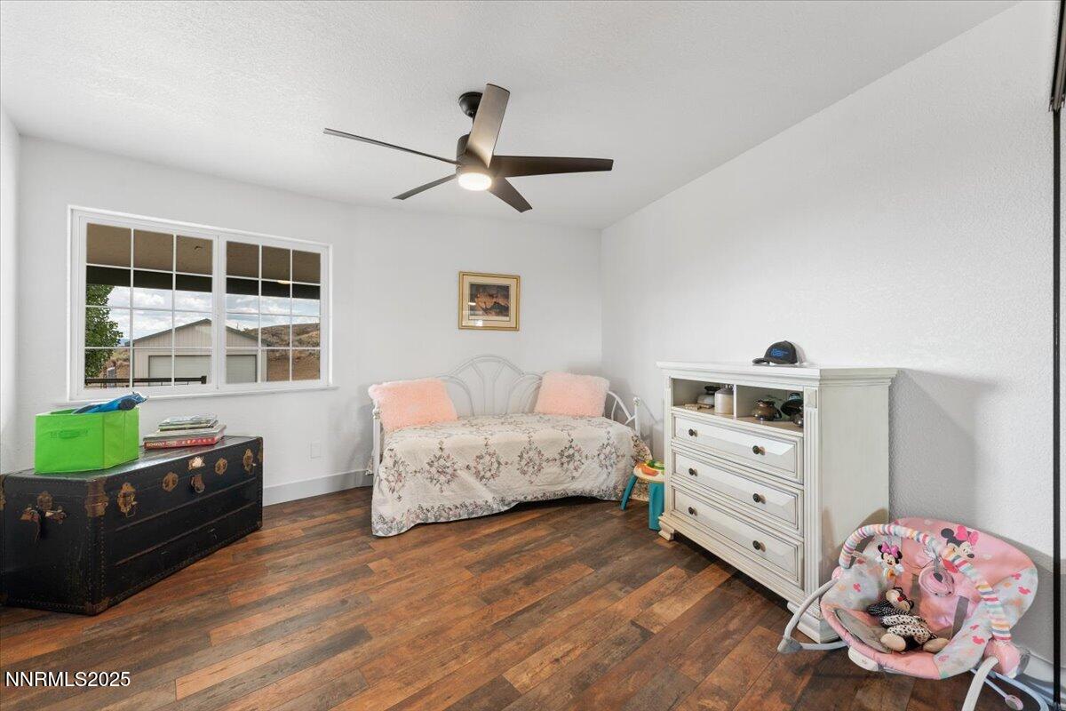 15030 North Red Rock Road Reno, NV 89508 - Photo 38 of 89 a spacious bedroom with a bed and wooden floor
