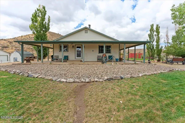 a view of a house with a backyard and a patio