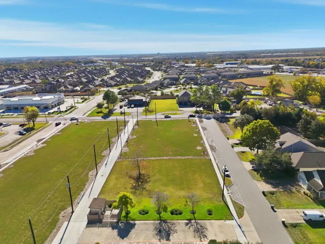 an aerial view of a residential houses with outdoor space
