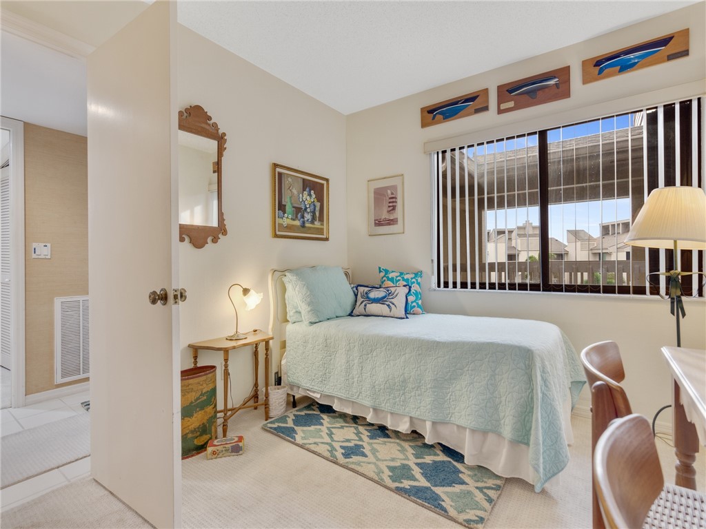 1880 Bay Road, Unit I319 Vero Beach, FL 32963 - Photo 15 of 36 a bedroom with a bed and a large window