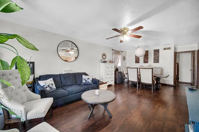 a living room with furniture and wooden floor