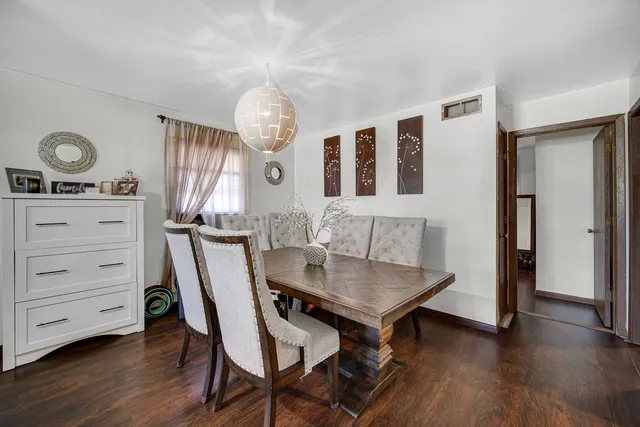 a view of a dining room with furniture and wooden floor