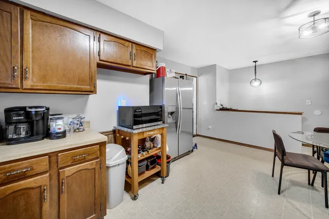 a kitchen with stainless steel appliances granite countertop a refrigerator sink and cabinets