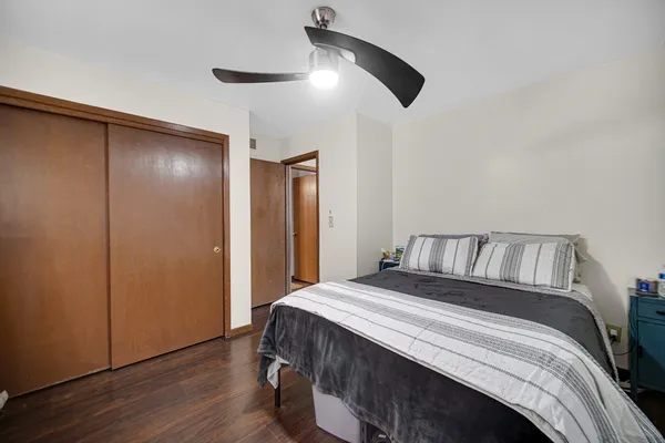 a bedroom with a large bed and a chandelier