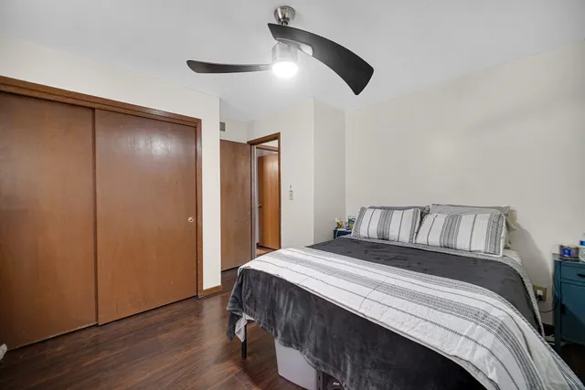 a bedroom with a large bed and a chandelier