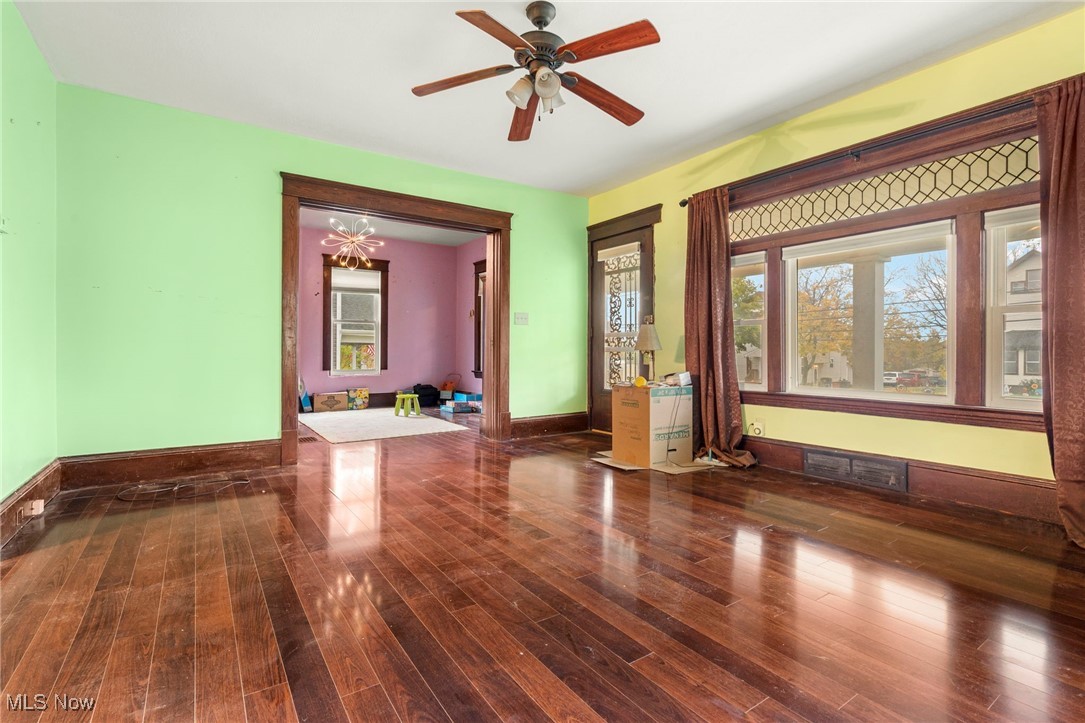 6453 Waterloo Road Atwater, OH 44201 - Photo 8 of 24 Unfurnished room featuring dark wood-style flooring, a chandelier, and a ceiling fan