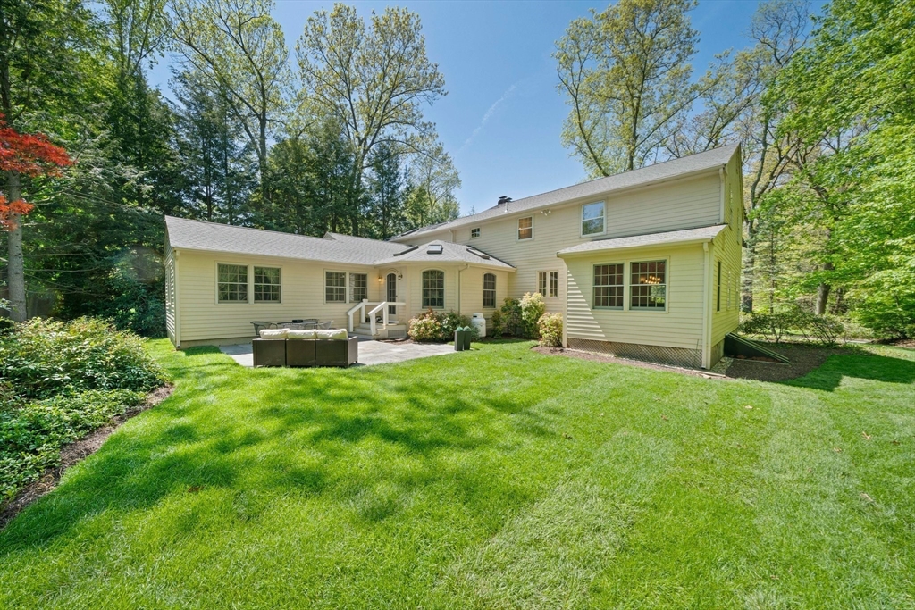 a view of a house with a backyard porch and sitting area