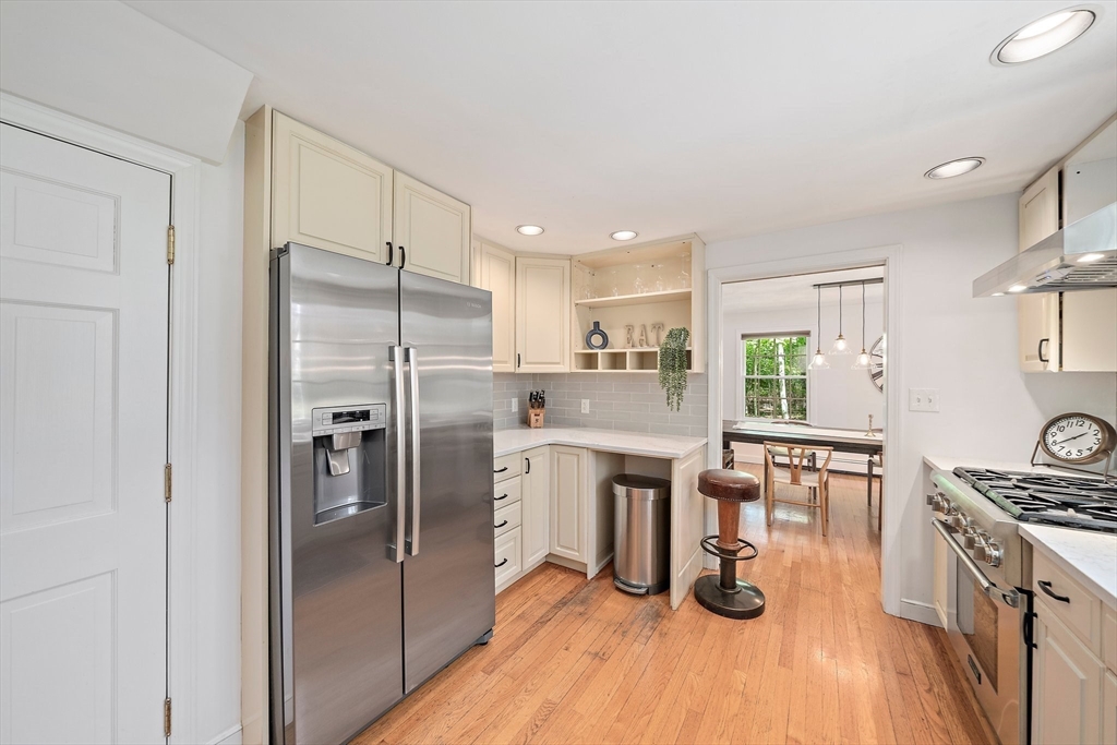 6 Garfield Street Lexington, MA 02421 - Photo 14 of 40 a kitchen with white cabinets and stainless steel appliances