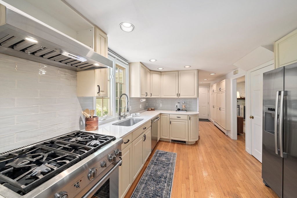 6 Garfield Street Lexington, MA 02421 - Photo 15 of 40 a kitchen with a stove a sink and a refrigerator