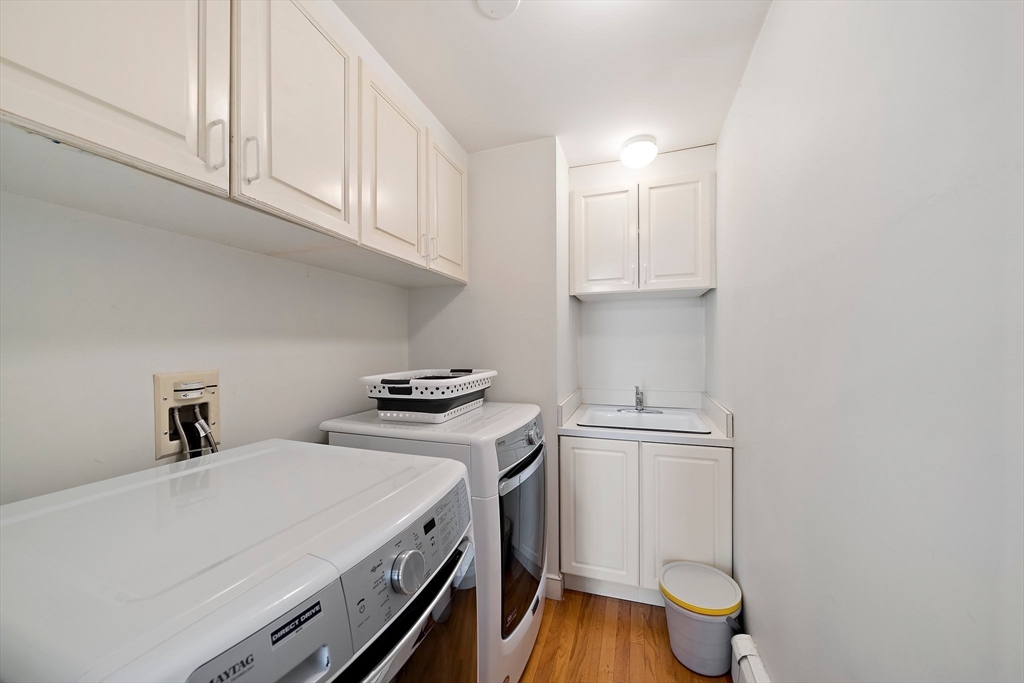 6 Garfield Street Lexington, MA 02421 - Photo 35 of 40 a view of a kitchen with sink and wooden floor