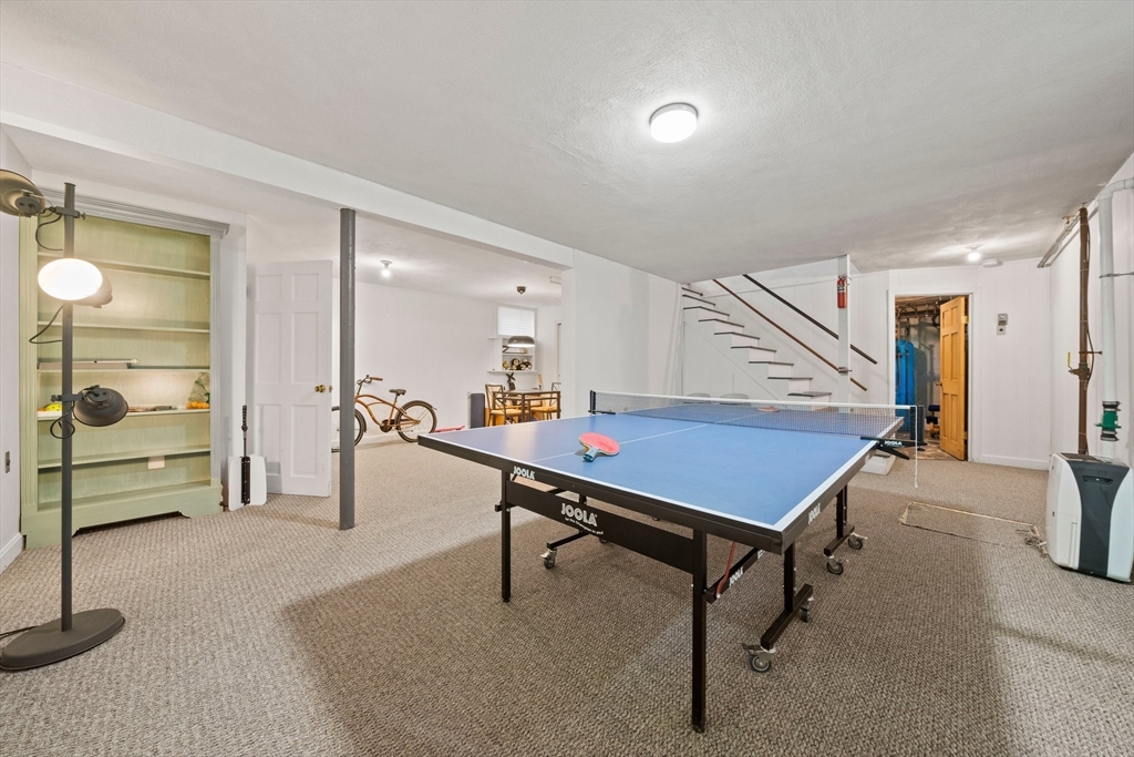 6 Garfield Street Lexington, MA 02421 - Photo 36 of 40 a room with table table tennis entryway and wooden floor
